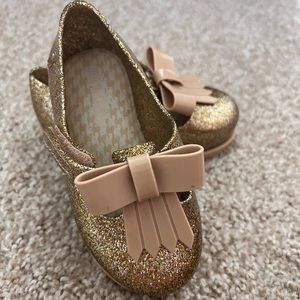 Mini Melissa shoes - never worn. Excellent condition and sparkly gold.